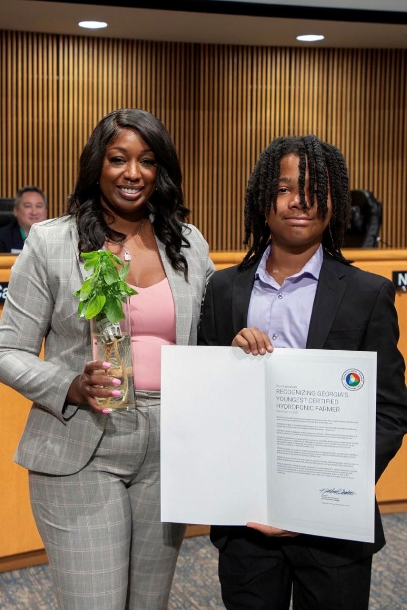Malon E.D. James and his mother, recieving an award.jpg